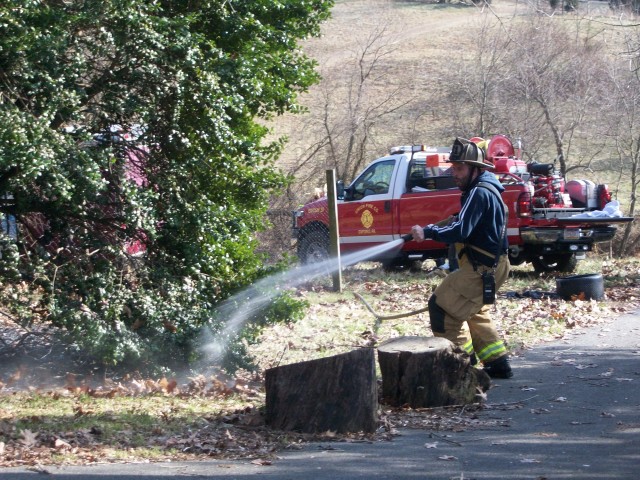 Captain Bob Prettyman extinguishes a brush fire in Nottingham.